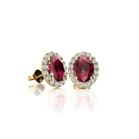 1 1/4 Carat Oval Shape Ruby And Halo Diamond Stud Earrings In 14 Karat Yellow Gold